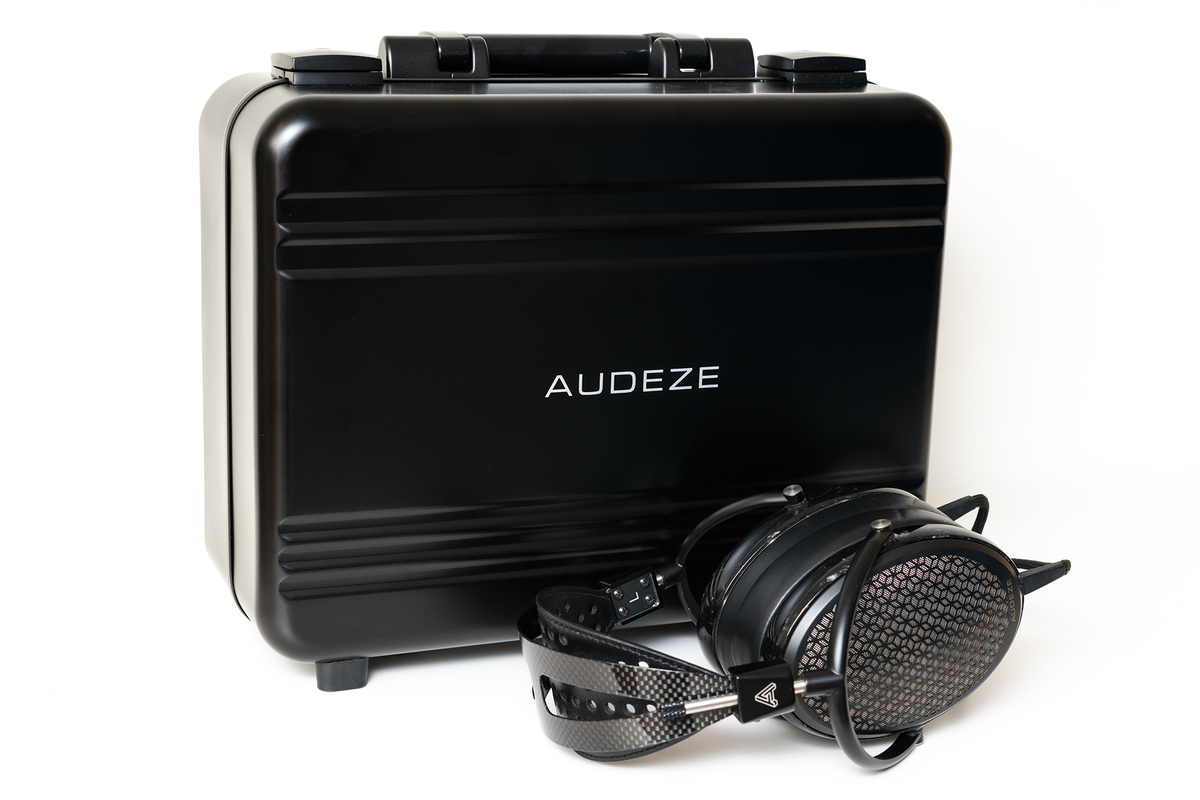 Audeze black headphone case with headphones, featuring metal accents and a sleek design. Perfect for audiophiles.