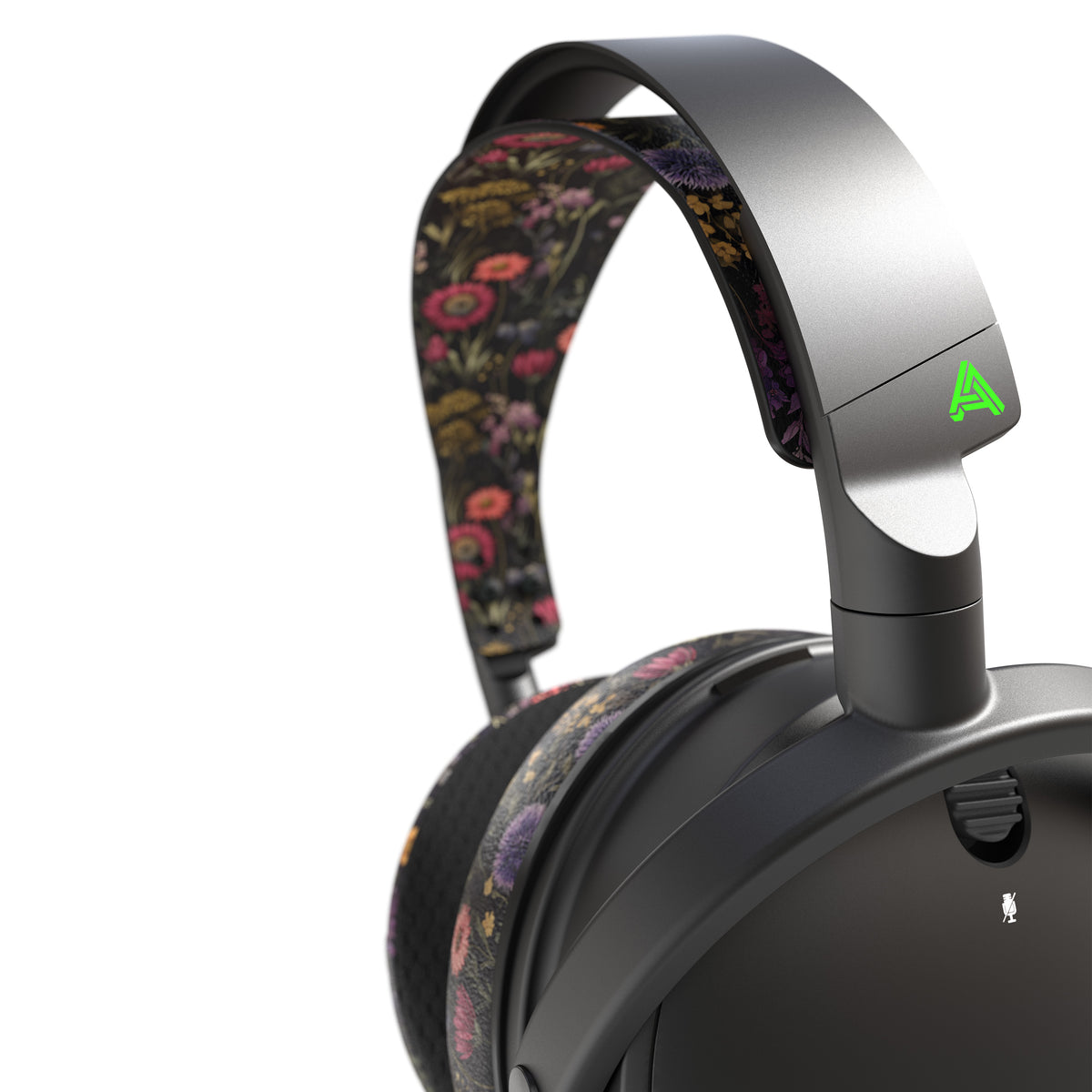 Floral-patterned wireless headphones with black finish and green accent, ideal for stylish audio enthusiasts.