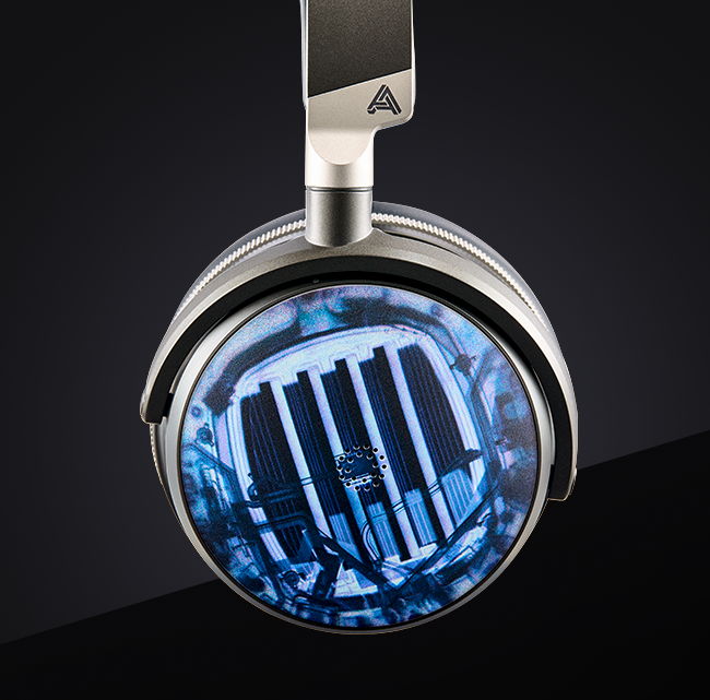 Silver over-ear headphones with a blue and black patterned speaker grille, featuring a sleek, modern design.